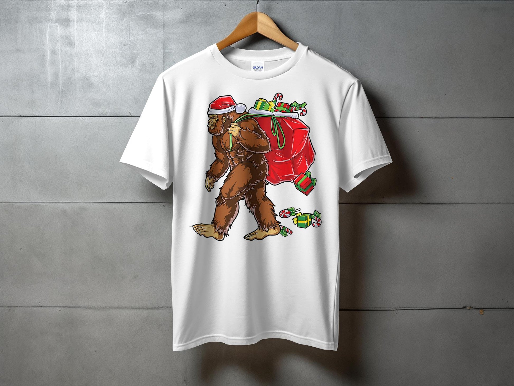 Bigfoot Carrying Presents Santa Hat Funny Christmas T-Shirt